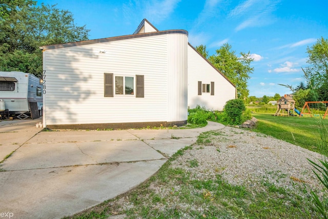 77280 Coon Creek Rd, Armada, MI 48005 - rear view of house with a playground and a yard