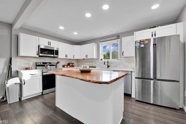 77280 Coon Creek Rd, Armada, MI 48005 - kitchen with appliances with stainless steel finishes, a center island, dark wood-type flooring, recessed lighting, and white cabinetry