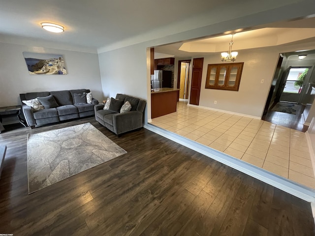 11485 Racine St, Warren, MI 48093 - living room with dark wood-style flooring, a chandelier, and a raised ceiling