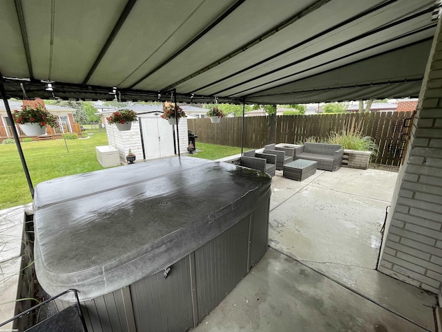 11485 Racine St, Warren, MI 48093 - fenced backyard with a patio area, a storage shed, and a hot tub