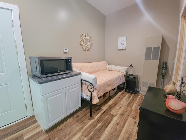 11339 Alpine Dr, Lake, MI 48632 - bedroom featuring a heating unit and light wood-style flooring