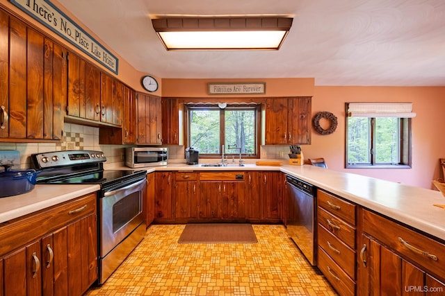 326 County Road Mp Rd, Negaunee, MI 49866 - kitchen with appliances with stainless steel finishes, light countertops, tasteful backsplash, and brown cabinets