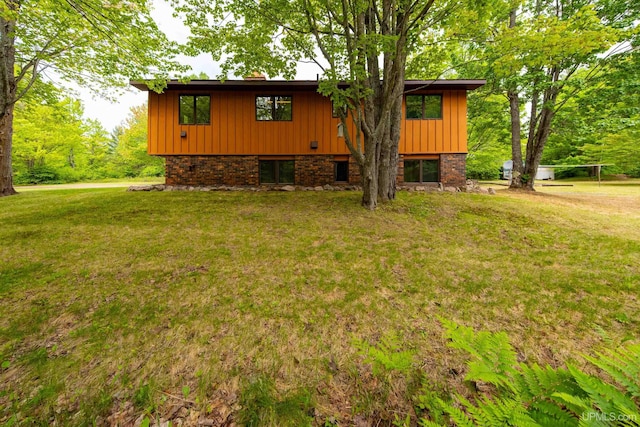326 County Road Mp Rd, Negaunee, MI 49866 - view of side of property featuring a lawn and board and batten siding