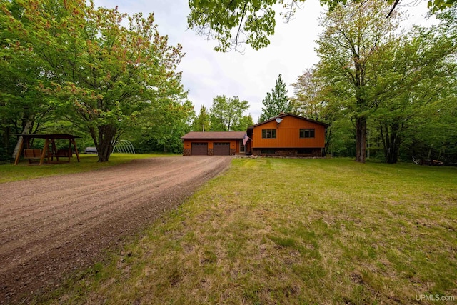 326 County Road Mp Rd, Negaunee, MI 49866 - view of front of house with a garage, dirt driveway, and a front yard
