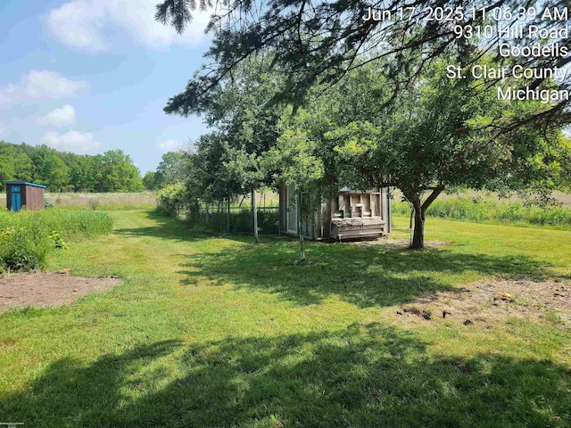 9310 Hill Rd, Wales, MI 48027 - view of grassy yard featuring a shed