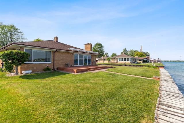 104 Marell St, East China, MI 48054 - rear view of house featuring brick siding, a chimney, a lawn, a shingled roof, and a deck with water view