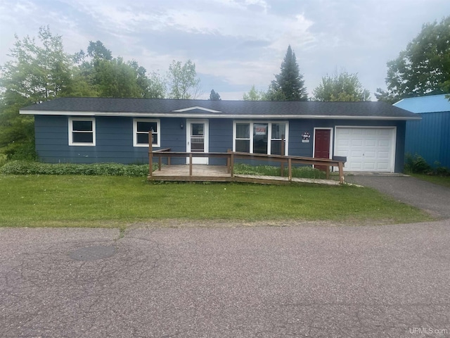 26121 S Calumet St, Laurium, MI 49913 - single story home with a garage, asphalt driveway, a front lawn, and a deck