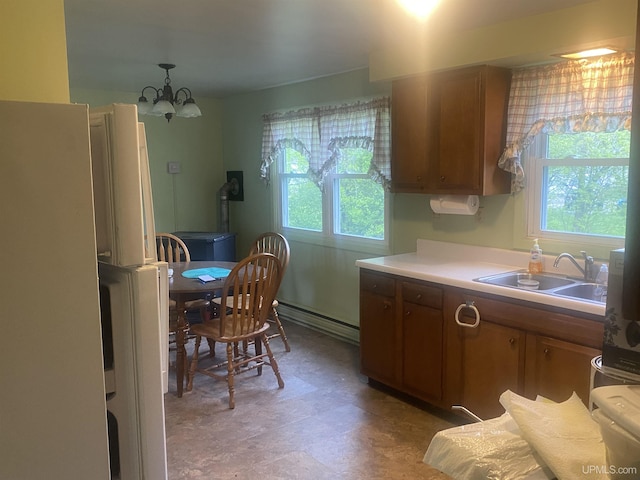 26121 S Calumet St, Laurium, MI 49913 - kitchen featuring healthy amount of natural light, baseboard heating, a chandelier, and light countertops