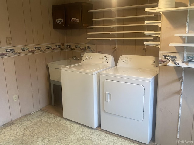 26121 S Calumet St, Laurium, MI 49913 - laundry room with washing machine and clothes dryer and wood walls