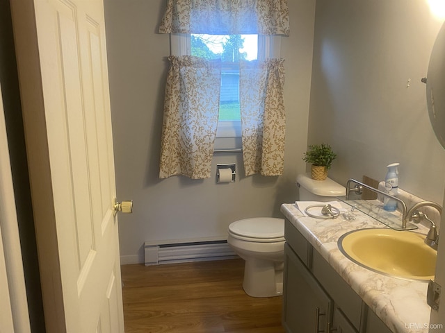 26121 S Calumet St, Laurium, MI 49913 - half bath featuring baseboard heating, vanity, and wood finished floors