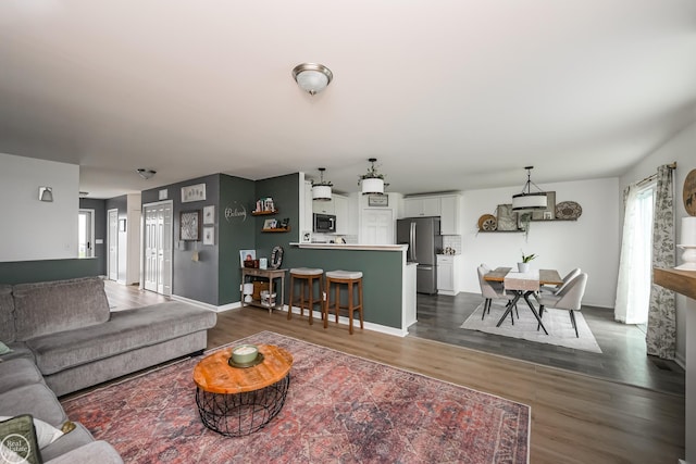 58530 Westmoore Cir, New Haven, MI 48048 - living area featuring dark wood-type flooring and plenty of natural light