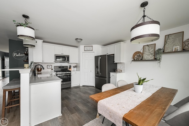 58530 Westmoore Cir, New Haven, MI 48048 - kitchen featuring appliances with stainless steel finishes, decorative backsplash, dark wood-style flooring, and white cabinets