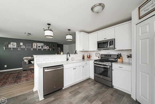58530 Westmoore Cir, New Haven, MI 48048 - kitchen with stainless steel appliances, decorative backsplash, and dark wood finished floors
