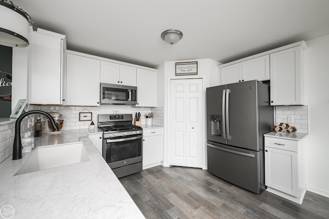 58530 Westmoore Cir, New Haven, MI 48048 - kitchen featuring stainless steel appliances, tasteful backsplash, and white cabinets