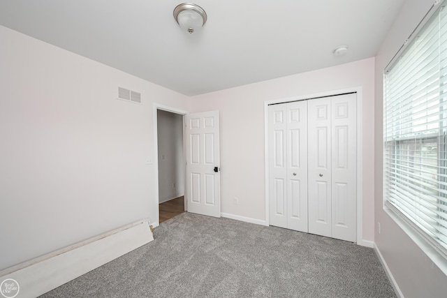 58530 Westmoore Cir, New Haven, MI 48048 - unfurnished bedroom featuring carpet flooring, multiple windows, and a closet