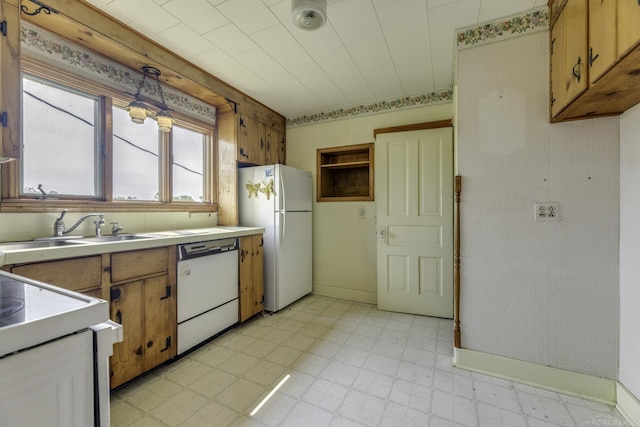 6410 Sheridan Line Rd, Croswell, MI 48422 - kitchen featuring white appliances, light countertops, pendant lighting, light floors, and brown cabinets