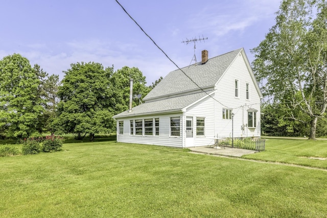 6410 Sheridan Line Rd, Croswell, MI 48422 - back of house featuring a chimney, a lawn, roof with shingles, and a patio