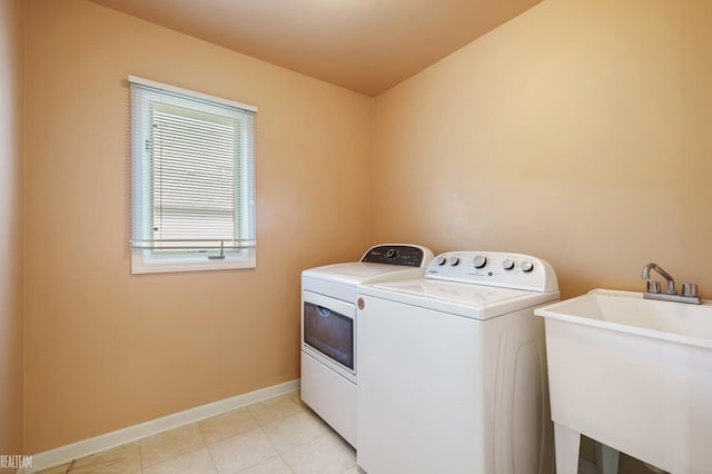 14060 Wayford Run, Shelby Twp, MI 48315 - laundry room with washer and clothes dryer and light tile patterned flooring