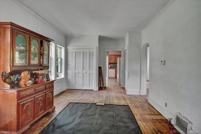 79050 Capac Rd, Armada, MI 48005 - bedroom featuring wood finished floors, arched walkways, ornamental molding, a closet, and freestanding refrigerator