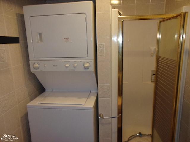 2221 N Channel Dr, Harsens Island, MI 48028 - washroom with stacked washer / dryer and tile walls