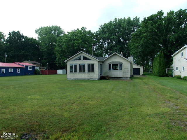 2221 N Channel Dr, Harsens Island, MI 48028 - rear view of property with a yard and view of scattered trees