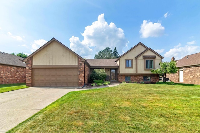 3667 Alderdale Dr, Sterling Heights, MI 48310 - tri-level home featuring an attached garage, driveway, a front yard, and brick siding