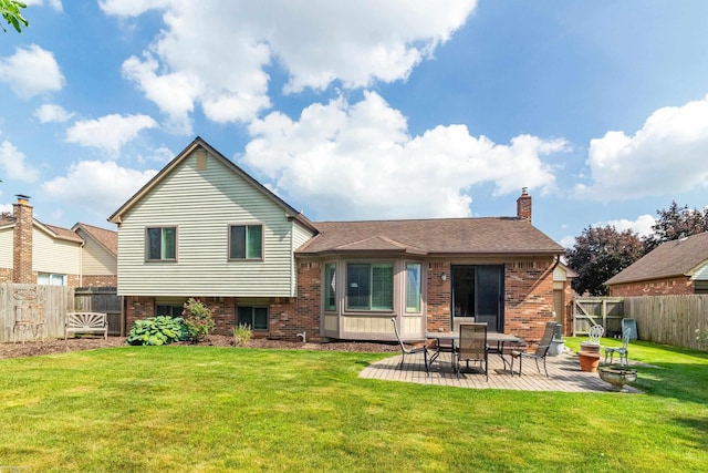 3667 Alderdale Dr, Sterling Heights, MI 48310 - back of property featuring brick siding, a fenced backyard, a patio, and a chimney