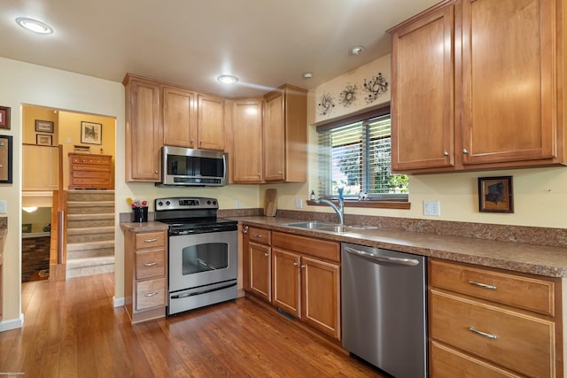 3667 Alderdale Dr, Sterling Heights, MI 48310 - kitchen featuring appliances with stainless steel finishes, dark wood finished floors, dark countertops, recessed lighting, and brown cabinets