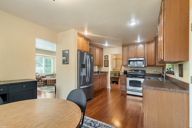 3667 Alderdale Dr, Sterling Heights, MI 48310 - kitchen featuring appliances with stainless steel finishes, dark countertops, dark wood-style floors, and recessed lighting