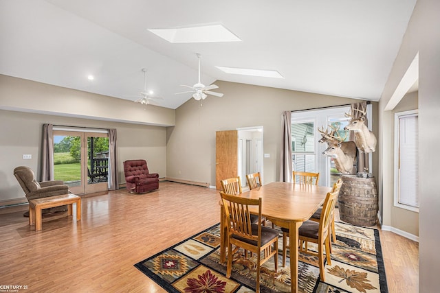 6920 Snover Rd, Decker, MI 48426 - dining space featuring a skylight, ceiling fan, light wood-style floors, and high vaulted ceiling
