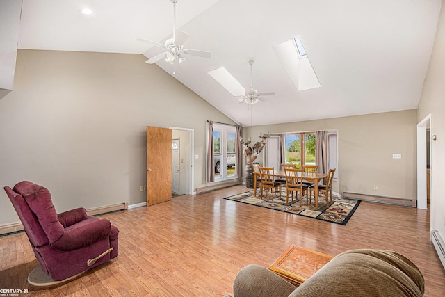 6920 Snover Rd, Decker, MI 48426 - living room with baseboard heating, a baseboard heating unit, high vaulted ceiling, a skylight, and ceiling fan