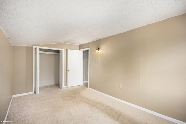 6920 Snover Rd, Decker, MI 48426 - unfurnished bedroom featuring a textured ceiling, light colored carpet, a closet, and lofted ceiling