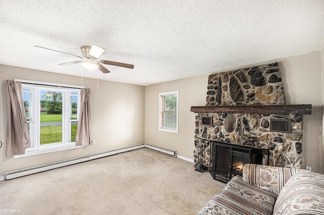 6920 Snover Rd, Decker, MI 48426 - living area featuring a baseboard heating unit, a ceiling fan, carpet flooring, a stone fireplace, and a textured ceiling