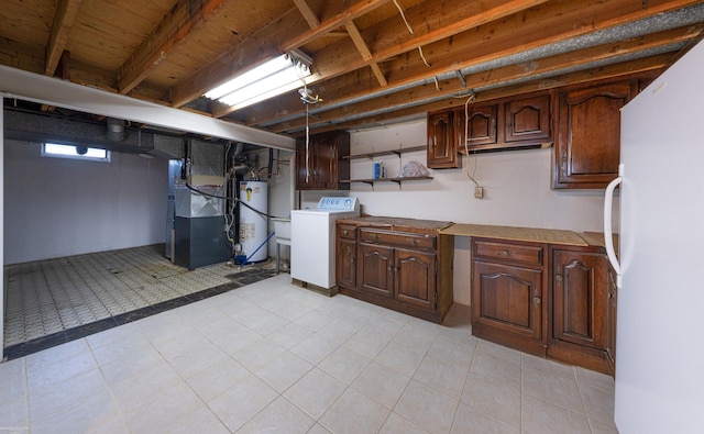 19300 Briarwood St, Clinton Township, MI 48036 - below grade area featuring washer / clothes dryer, freestanding refrigerator, water heater, heating unit, and light tile patterned floors