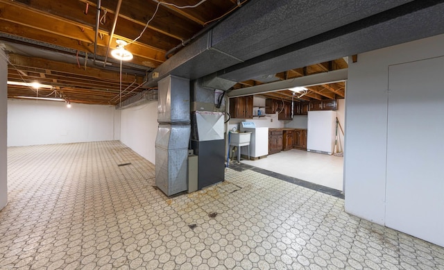 19300 Briarwood St, Clinton Township, MI 48036 - below grade area with freestanding refrigerator, heating unit, washer / clothes dryer, and light flooring