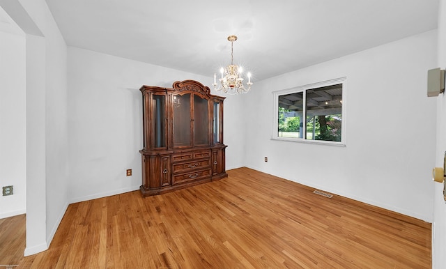 19300 Briarwood St, Clinton Township, MI 48036 - empty room with light wood-style flooring and a chandelier
