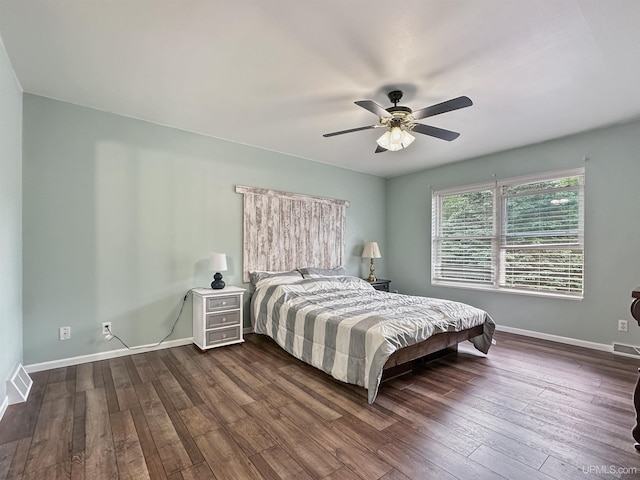 8302 W Burntwood P.15 Dr, Gladstone, MI 49837 - bedroom with dark wood-type flooring and a ceiling fan