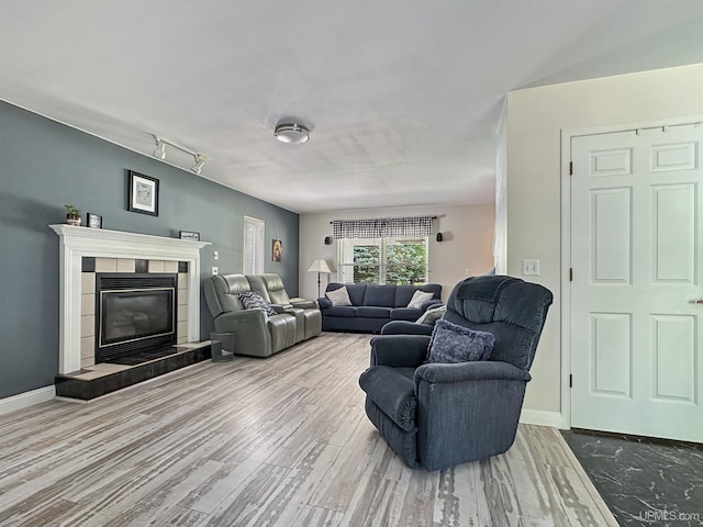8302 W Burntwood P.15 Dr, Gladstone, MI 49837 - living area with wood finished floors and a tile fireplace