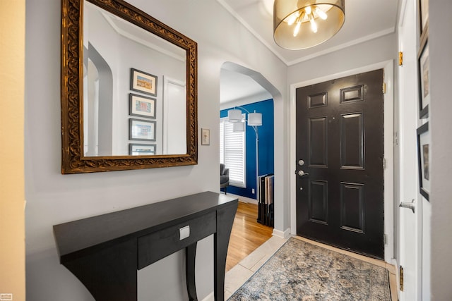 1006 W 12 Mile Rd, Royal Oak, MI 48073 - foyer entrance featuring arched walkways, crown molding, and light wood-style flooring
