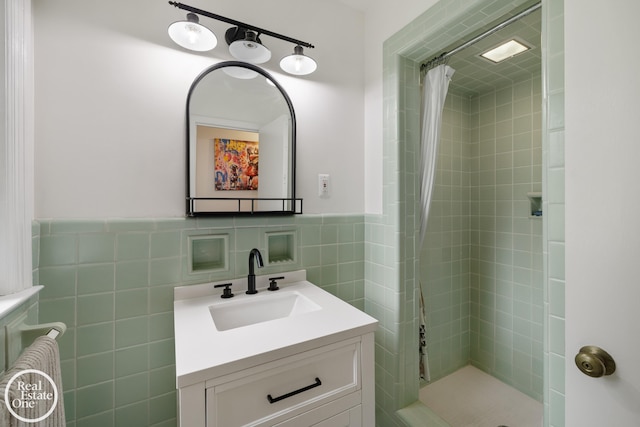 1033 Cadieux Rd, Grosse Pointe, MI 48230 - bathroom featuring vanity, a shower stall, tile walls, and a wainscoted wall
