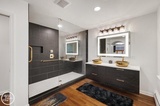 1033 Cadieux Rd, Grosse Pointe, MI 48230 - full bath with vanity, wood finished floors, a stall shower, recessed lighting, and a baseboard radiator