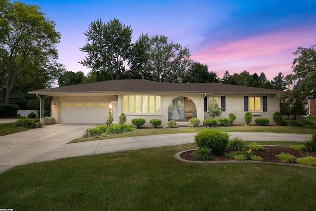 5350 Fieldcrest Dr, Shelby Twp, MI 48316 - ranch-style house with driveway, a front lawn, brick siding, and a garage