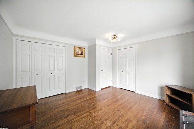 5350 Fieldcrest Dr, Shelby Twp, MI 48316 - unfurnished bedroom featuring wood finished floors and multiple closets