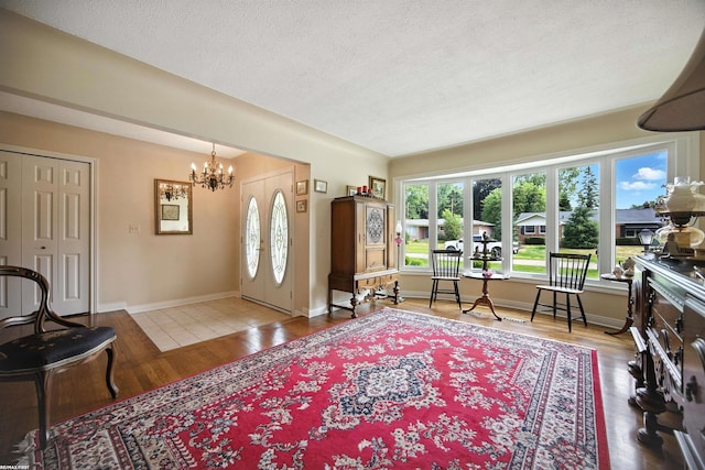 5350 Fieldcrest Dr, Shelby Twp, MI 48316 - foyer with a chandelier, wood finished floors, and a textured ceiling