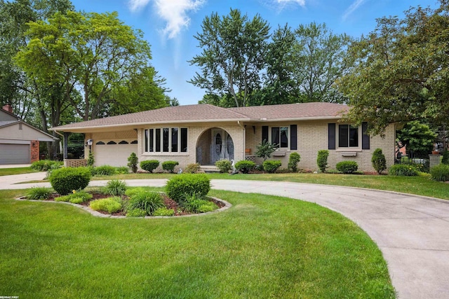 5350 Fieldcrest Dr, Shelby Twp, MI 48316 - ranch-style house featuring curved driveway, an attached garage, a front yard, and brick siding