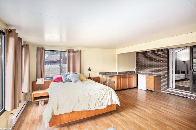46329 Community Center Dr, Chesterfield Twp, MI 48047 - bedroom featuring a baseboard heating unit, light wood-style flooring, and access to outside