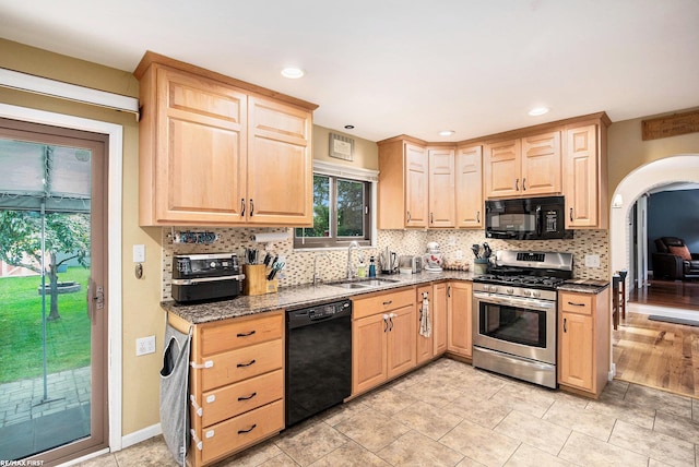 46329 Community Center Dr, Chesterfield Twp, MI 48047 - kitchen with black appliances, light brown cabinetry, arched walkways, and recessed lighting