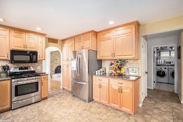 46329 Community Center Dr, Chesterfield Twp, MI 48047 - kitchen with appliances with stainless steel finishes, separate washer and dryer, light brown cabinetry, tasteful backsplash, and dark stone counters