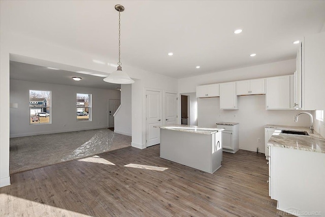 1718 W 12 Mile Rd, Royal Oak, MI 48073 - kitchen with a kitchen island, wood finished floors, recessed lighting, white cabinetry, and decorative light fixtures