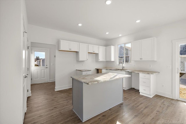 1718 W 12 Mile Rd, Royal Oak, MI 48073 - kitchen featuring healthy amount of natural light, wood finished floors, white cabinets, and recessed lighting